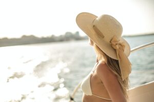A woman with a hat on the beach